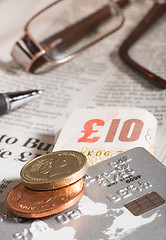 Image showing Glasses, coins, credit cards and banknotes on newspaper