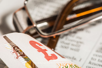 Image showing Glasses, coins, credit cards and banknotes on newspaper