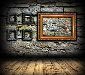 Image showing stone wall with wood painting frames