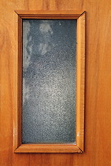 Image showing window in wood door, textured plywood 