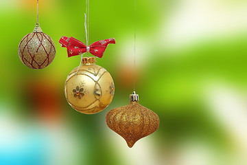 Image showing three gold christmas baubles