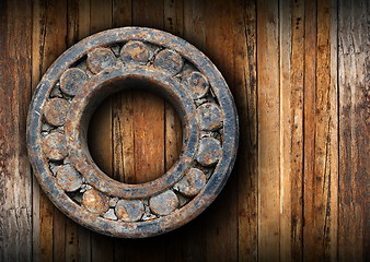 Image showing huge rusty ball bearing hung on the wall