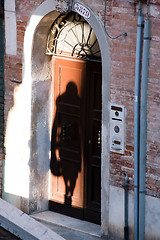 Image showing shadow silhouette of woman in the street door