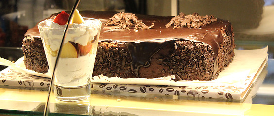 Image showing chocolate cake and ice-cream in the shopwindow