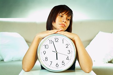 Image showing brunette with clock