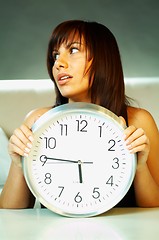 Image showing brunette with clock