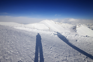 Image showing Shadows of skier and snowboarder on snow