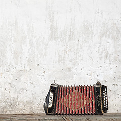 Image showing wall and accordion on the bench