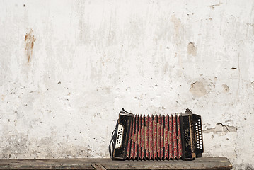 Image showing wall and accordion on the bench background