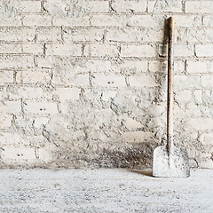 Image showing grunge wall background at the mill, shovel near the wall