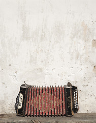 Image showing wall and accordion on the bench