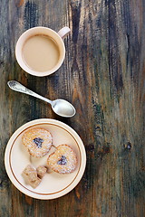 Image showing Coffee saucer with biscuits and cane sugar.