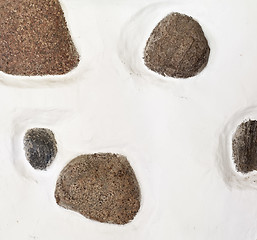 Image showing stones in stucco wall