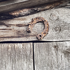 Image showing horseshoe on the plank wall