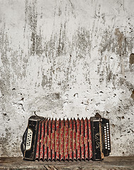 Image showing wall and accordion on the bench background