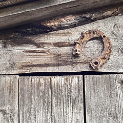 Image showing horseshoe on the plank wall