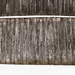 Image showing plank wooden wall in winter, snow on the ground