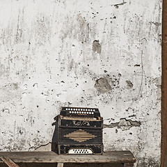 Image showing wall and accordion on the bench background