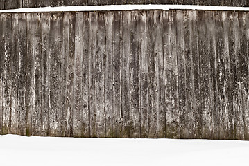 Image showing plank wooden wall in winter, snow on the ground