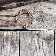 Image showing horseshoe on the plank wall