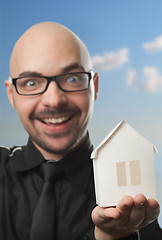 Image showing Man holding a paper house.