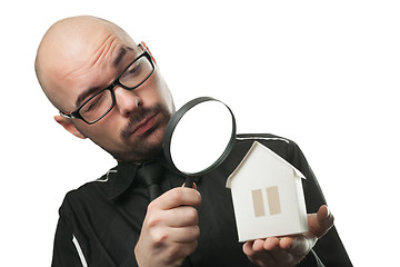 Image showing Man with a magnifying glass and paper house