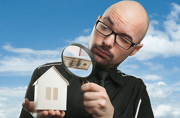 Image showing Man with a magnifying glass and paper house