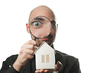 Image showing Man with a magnifying glass and paper house