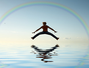 Image showing jump over water under rainbow