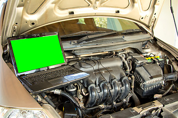 Image showing Car mechanic checking engine