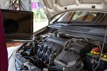 Image showing Car mechanic checking engine