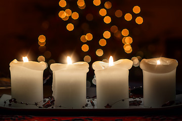 Image showing Burning candle with christmas tree bokeh