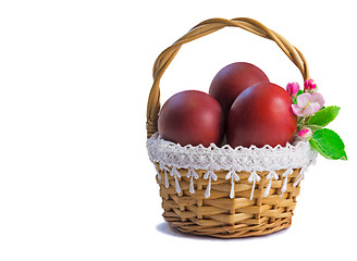 Image showing Red Easter eggs in a basket on a white background.