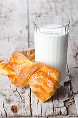 Image showing glass of milk and two fresh baked buns 