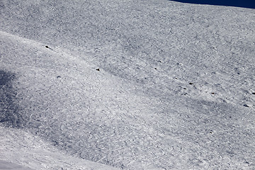 Image showing Traces of skis and snowboards on off-piste slope at sun day