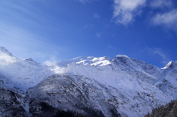 Image showing Snowy sunlight mountains, view from ski slope