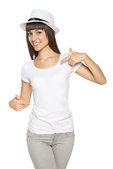 Image showing Smiling woman pointing at blank white t-shirt