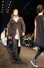Image showing Asian male model on the catwalk during a fashion show - EDITORIA