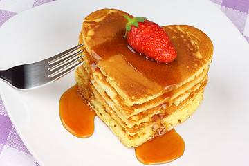 Image showing Heart-shaped pancakes with syrup and strawberry