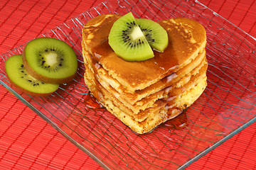 Image showing Heart-shaped pancakes with syrup and kiwi fruit