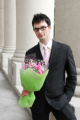 Image showing Man with a bunch of flowers.