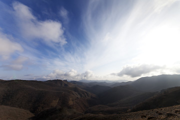 Image showing Mountains and blue sky with clouds