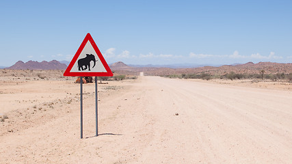 Image showing Caution: Elephants! Road sign standing beside road