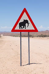 Image showing Caution: Elephants! Road sign standing beside road