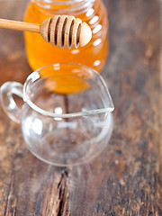 Image showing natural honey with a clean dipper 