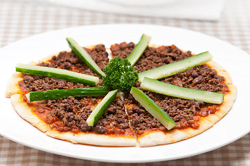 Image showing Turkish beef pizza with cucumber on top