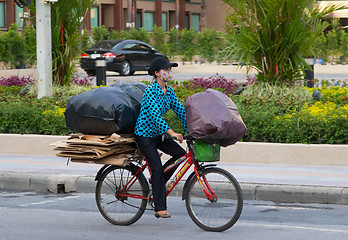 Image showing Patong  - APRIL 26: Thai woman takes out the garbage in bags on 