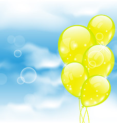 Image showing Flying yellow balloons in blue sky