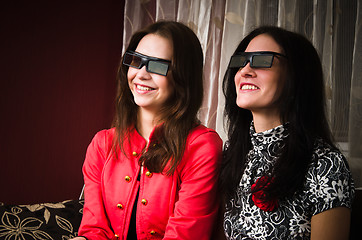 Image showing Two beautiful women at home watching a 3D movie