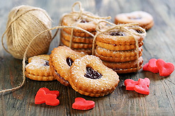 Image showing Red marzipan hearts, cookies and ball of twine.